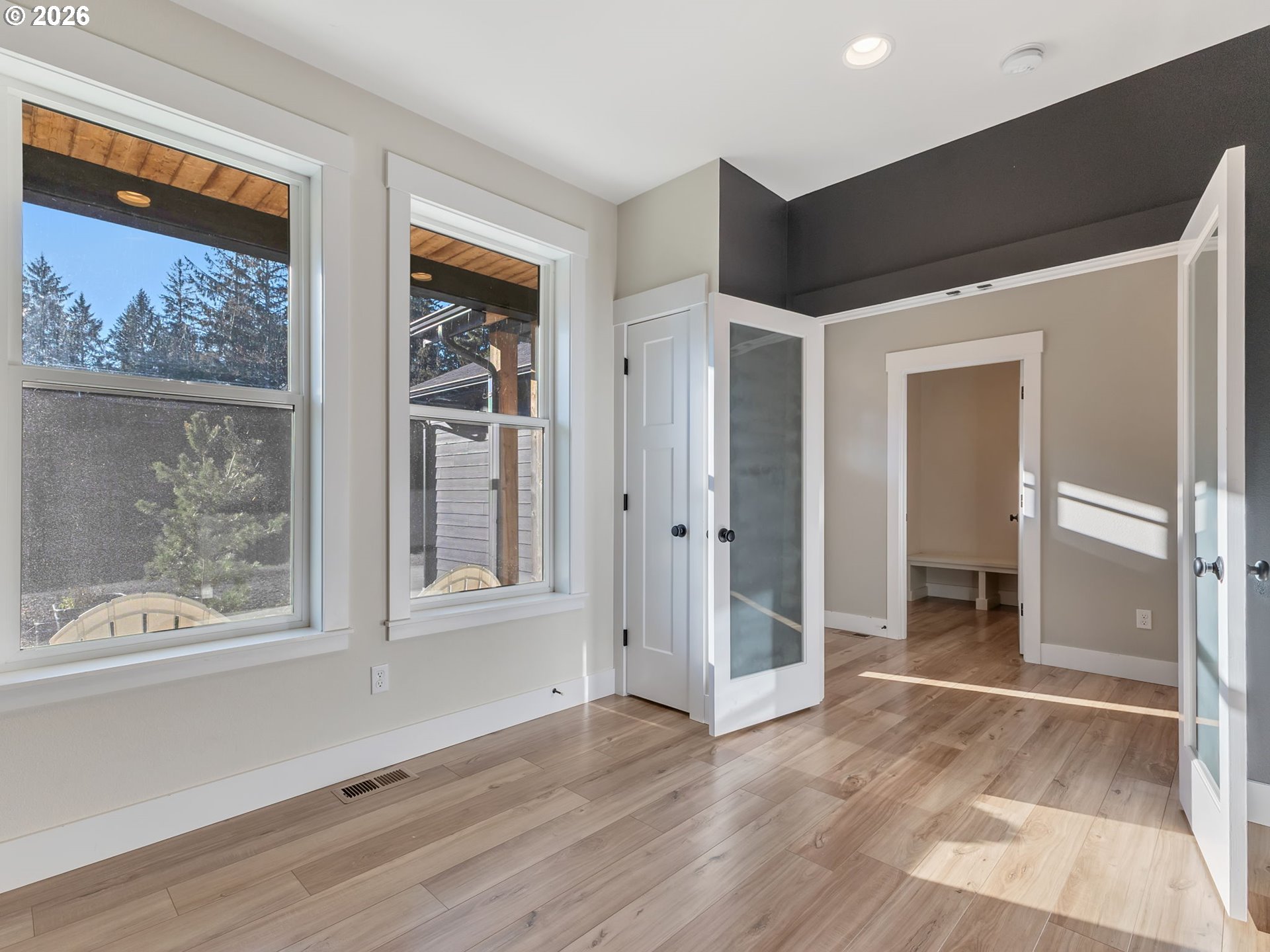 37027 Danner Ridge Lane Astoria, OR 97103 - Photo 6 of 46 an empty room with wooden floor and windows