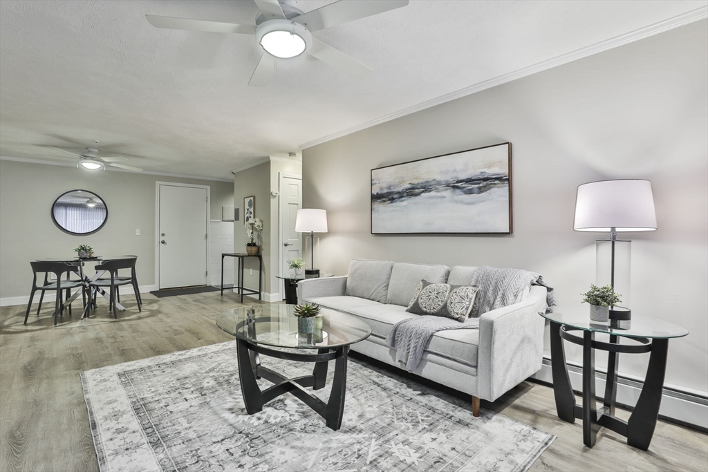 5 Karen Circle, Unit 4 Billerica, MA 01821 - Photo 5 of 12 a living room with furniture a clock on wall and a table