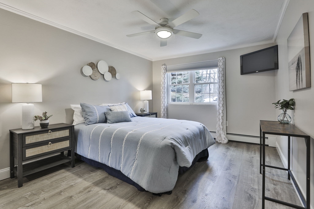 5 Karen Circle, Unit 4 Billerica, MA 01821 - Photo 9 of 12 a spacious bedroom with a bed and a flat screen tv