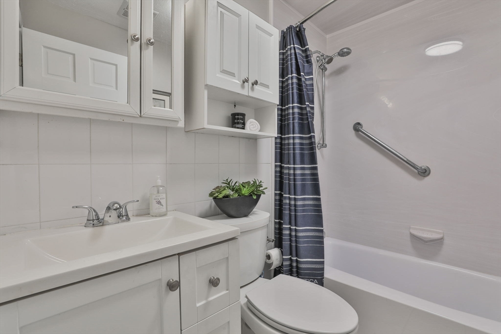 5 Karen Circle, Unit 4 Billerica, MA 01821 - Photo 10 of 12 a bathroom with a sink toilet and shower