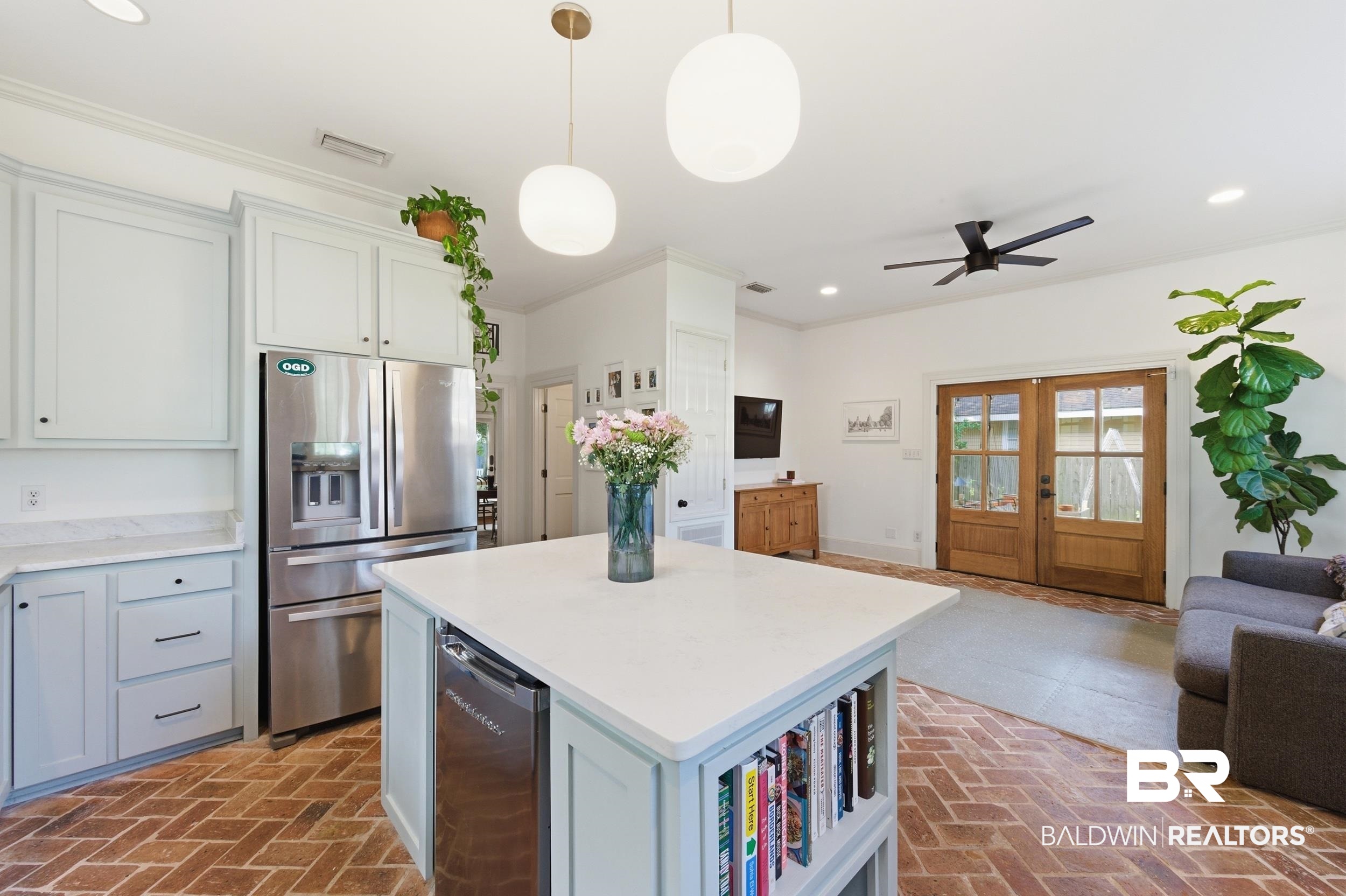 350 Charles Street Mobile, AL 36604 - Photo 7 of 52 Kitchen featuring light-toned cabinetry, stainless steel appliances, and a central island with integrated shelving