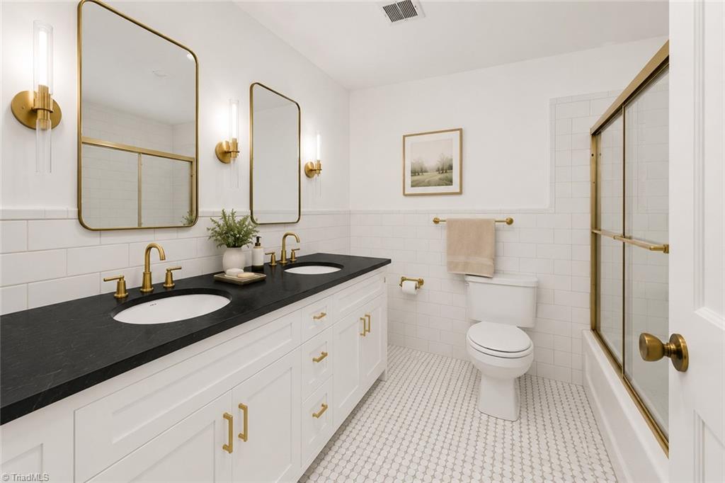 626 Kenneth Road Greensboro, NC 27455 - Photo 15 of 34 Digitally enhanced. Hall bath with double sinks