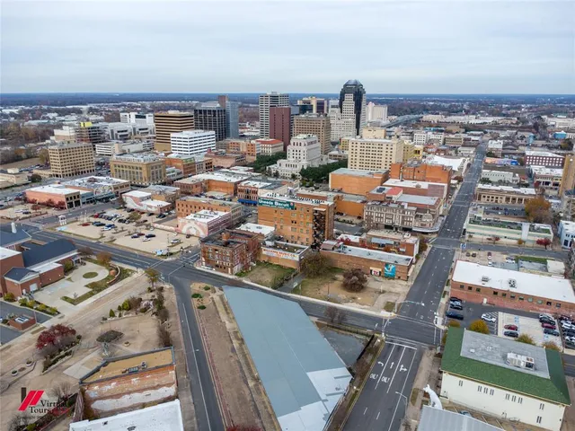 a view of a building with staircase and wooden fence