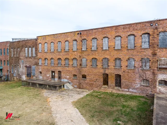 a view of a building with a table and chairs
