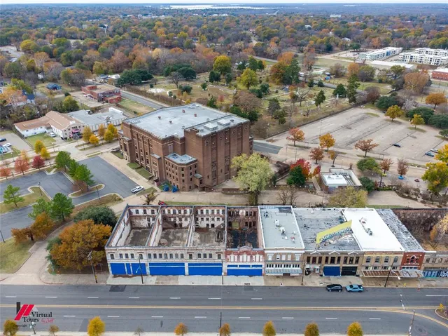 an aerial view of a residential building with an outdoor space