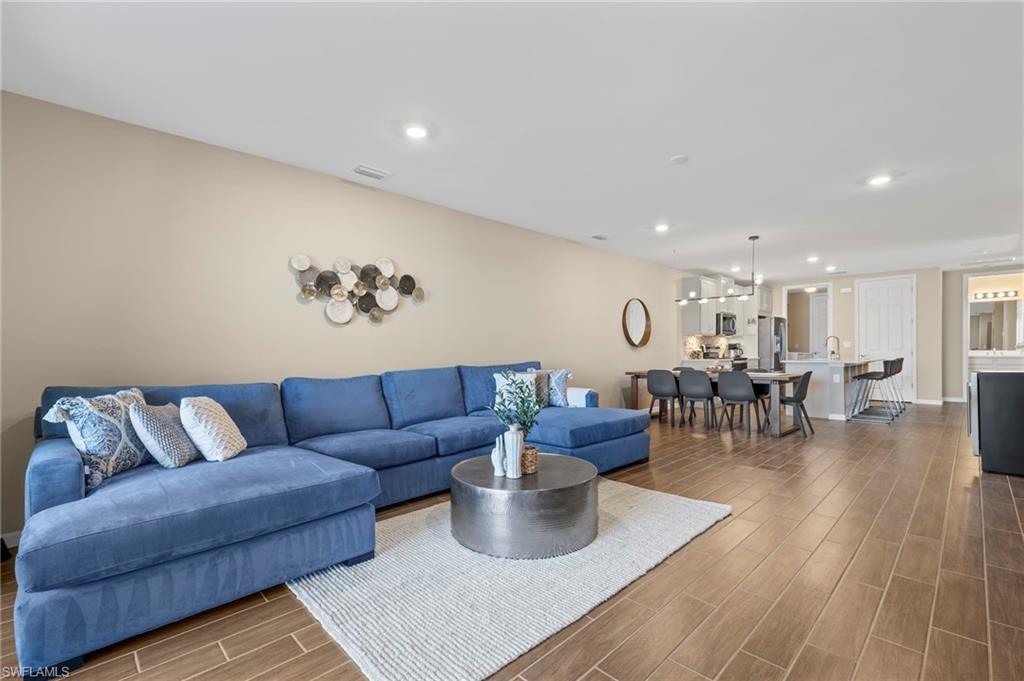 14644 Edgewater Circle Naples, FL 34114 - Photo 4 of 39 a living room with furniture and wooden floor
