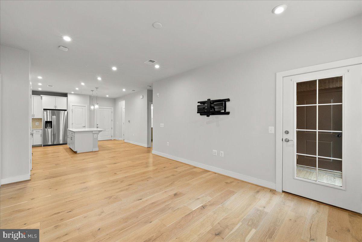 2320 Field Point Road, Unit 103 Herndon, VA 20171 - Photo 17 of 22 a view of an empty room with wooden floor and windows