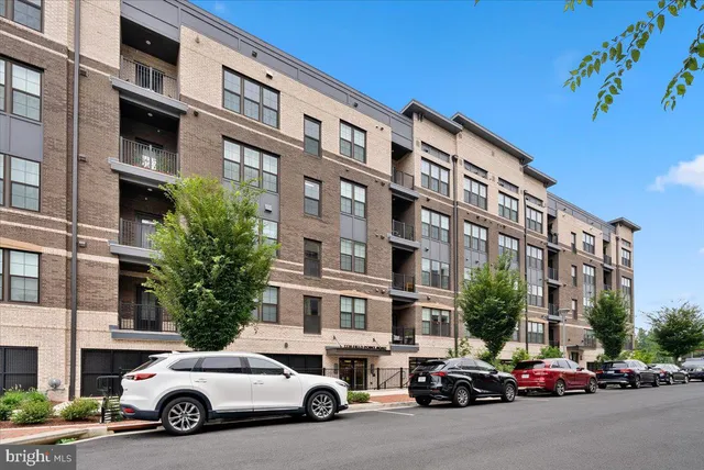 a front view of a residential apartment building with a yard