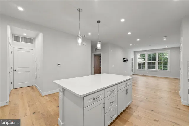 a spacious bathroom with a granite countertop sink and a large mirror