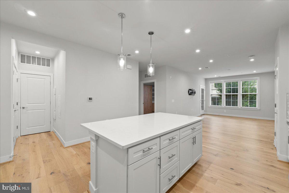 2320 Field Point Road, Unit 103 Herndon, VA 20171 - Photo 3 of 22 a spacious bathroom with a granite countertop sink and a large mirror