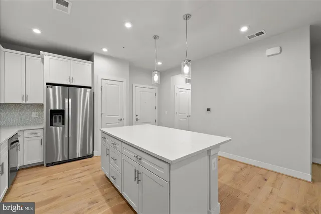 a kitchen with a refrigerator a sink and a oven