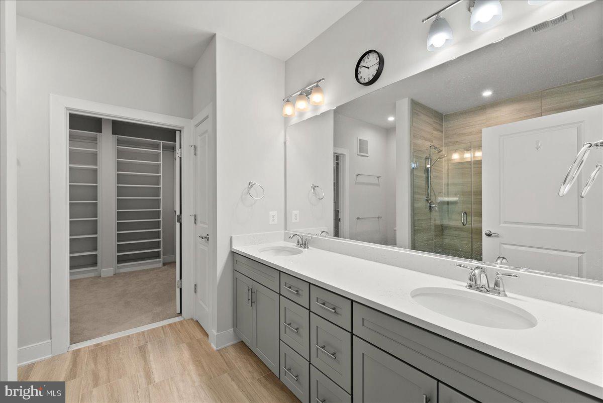 2320 Field Point Road, Unit 103 Herndon, VA 20171 - Photo 9 of 22 a bathroom with double vanity sinks and a shower