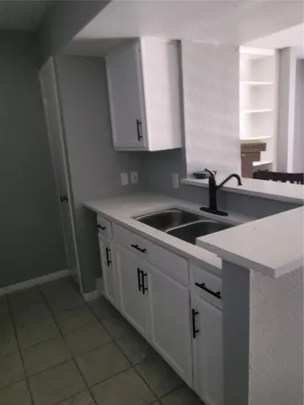 a kitchen that has a sink and a stove