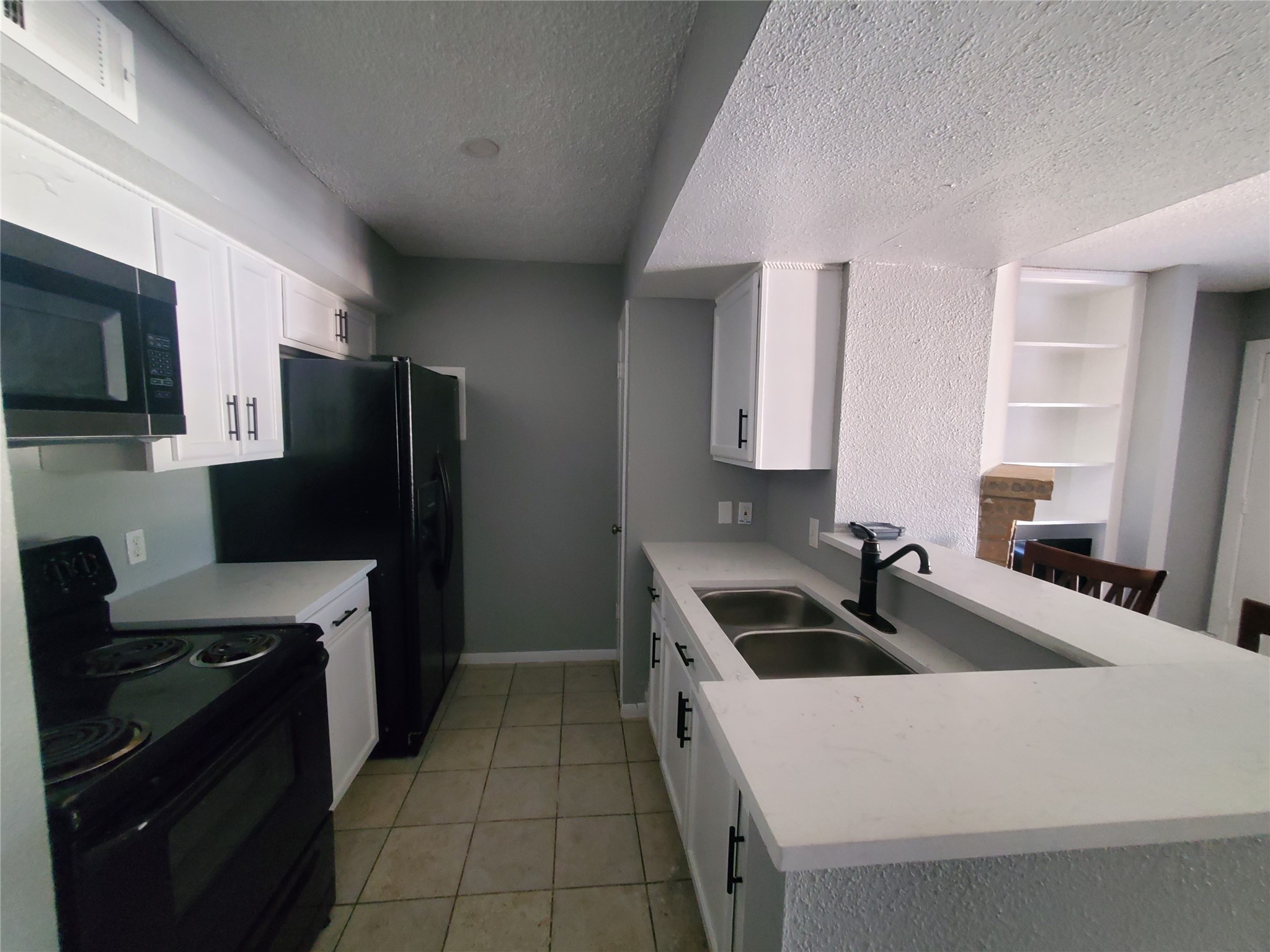 1505 Ward Road, Unit 218 Baytown, TX 77520 - Photo 9 of 17 a kitchen that has a sink and a stove