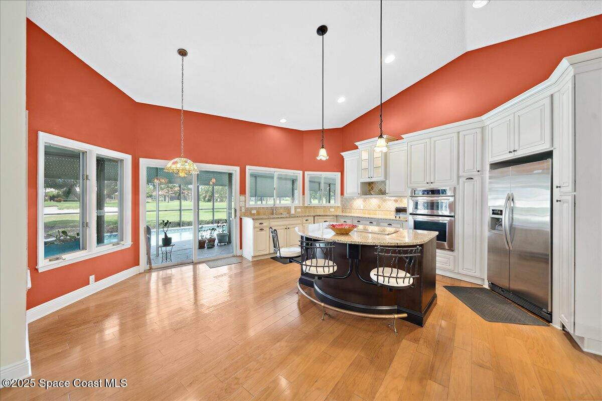 649 Spring Lake Drive Melbourne, FL 32940 - Photo 13 of 47 a kitchen with stainless steel appliances granite countertop a sink a stove and a refrigerator
