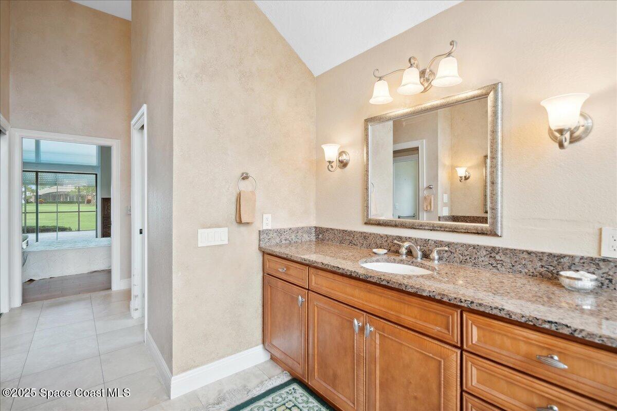 649 Spring Lake Drive Melbourne, FL 32940 - Photo 18 of 47 a bathroom with a granite countertop sink and a mirror