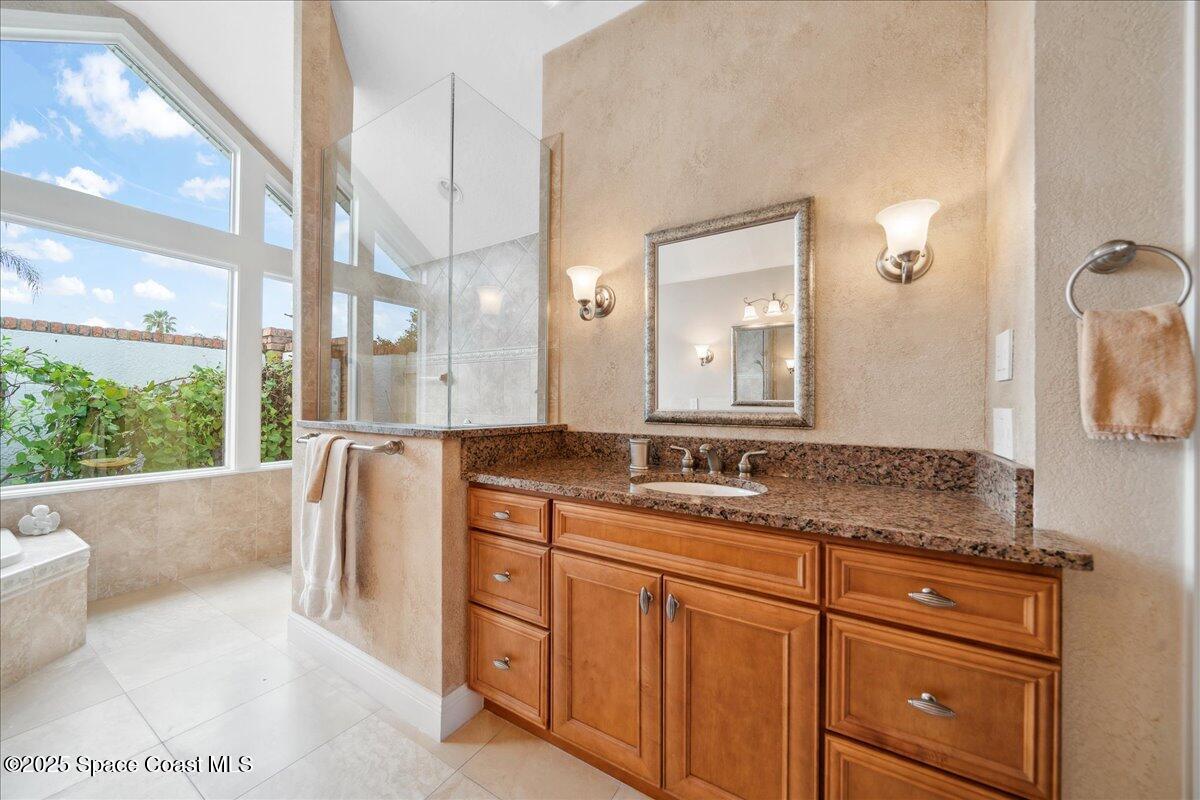 649 Spring Lake Drive Melbourne, FL 32940 - Photo 19 of 47 a bathroom with a granite countertop sink and mirror bathtub