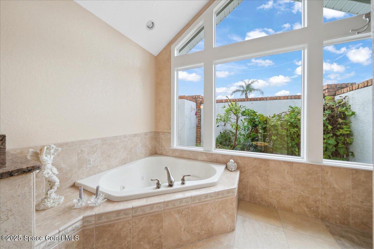 649 Spring Lake Drive Melbourne, FL 32940 - Photo 20 of 47 a white bath tub sitting in a bathroom next to a window