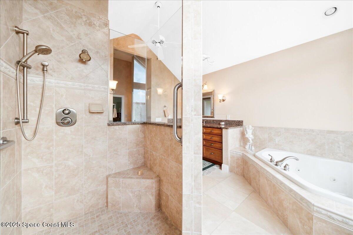 649 Spring Lake Drive Melbourne, FL 32940 - Photo 21 of 47 a bathroom with a bathtub and a shower