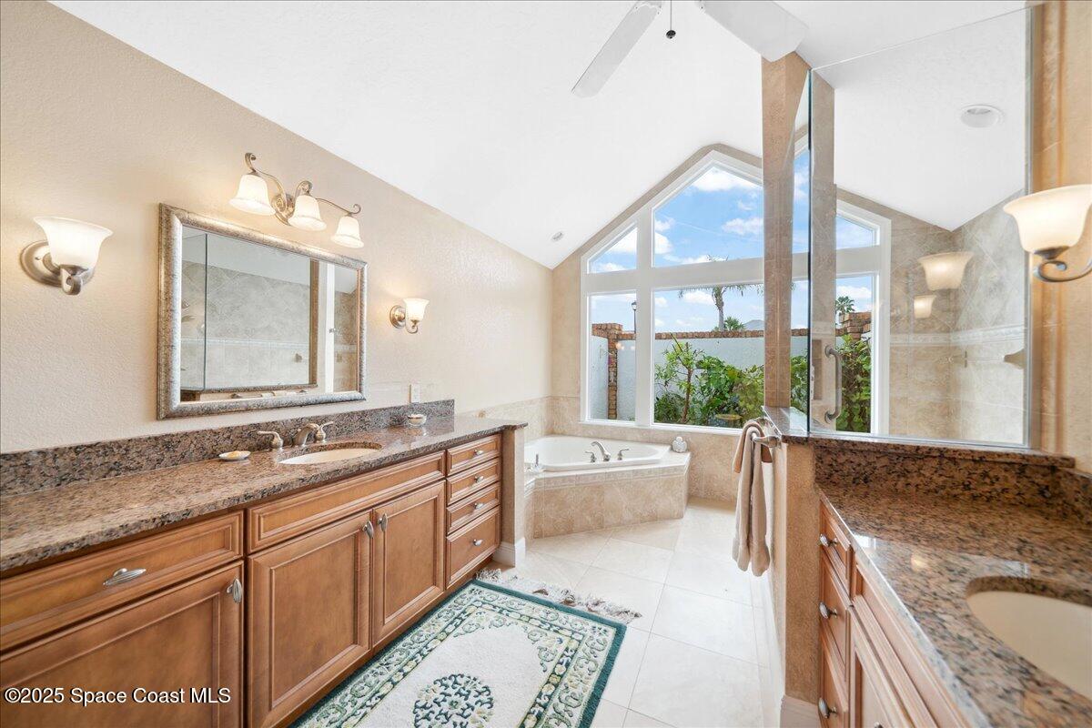 649 Spring Lake Drive Melbourne, FL 32940 - Photo 22 of 47 a spacious bathroom with a granite countertop tub sink and mirror