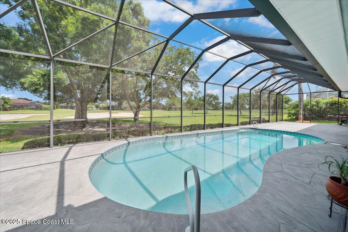 649 Spring Lake Drive Melbourne, FL 32940 - Photo 29 of 47 a view of a swimming pool with a porch