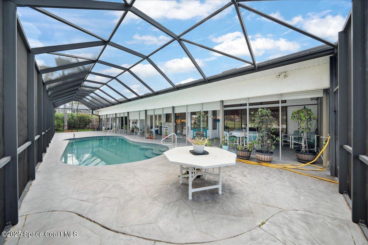649 Spring Lake Drive Melbourne, FL 32940 - Photo 33 of 47 a view of a swimming pool with a patio
