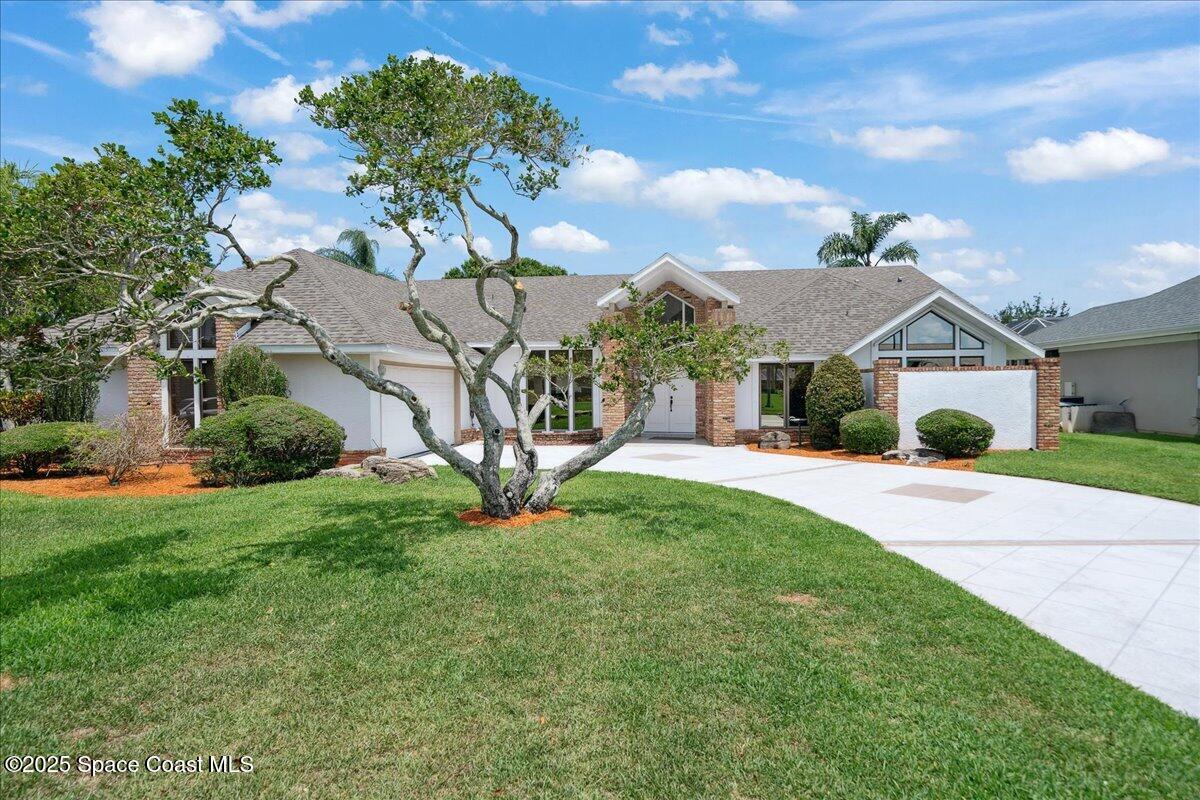 649 Spring Lake Drive Melbourne, FL 32940 - Photo 4 of 47 a front view of a house with a yard