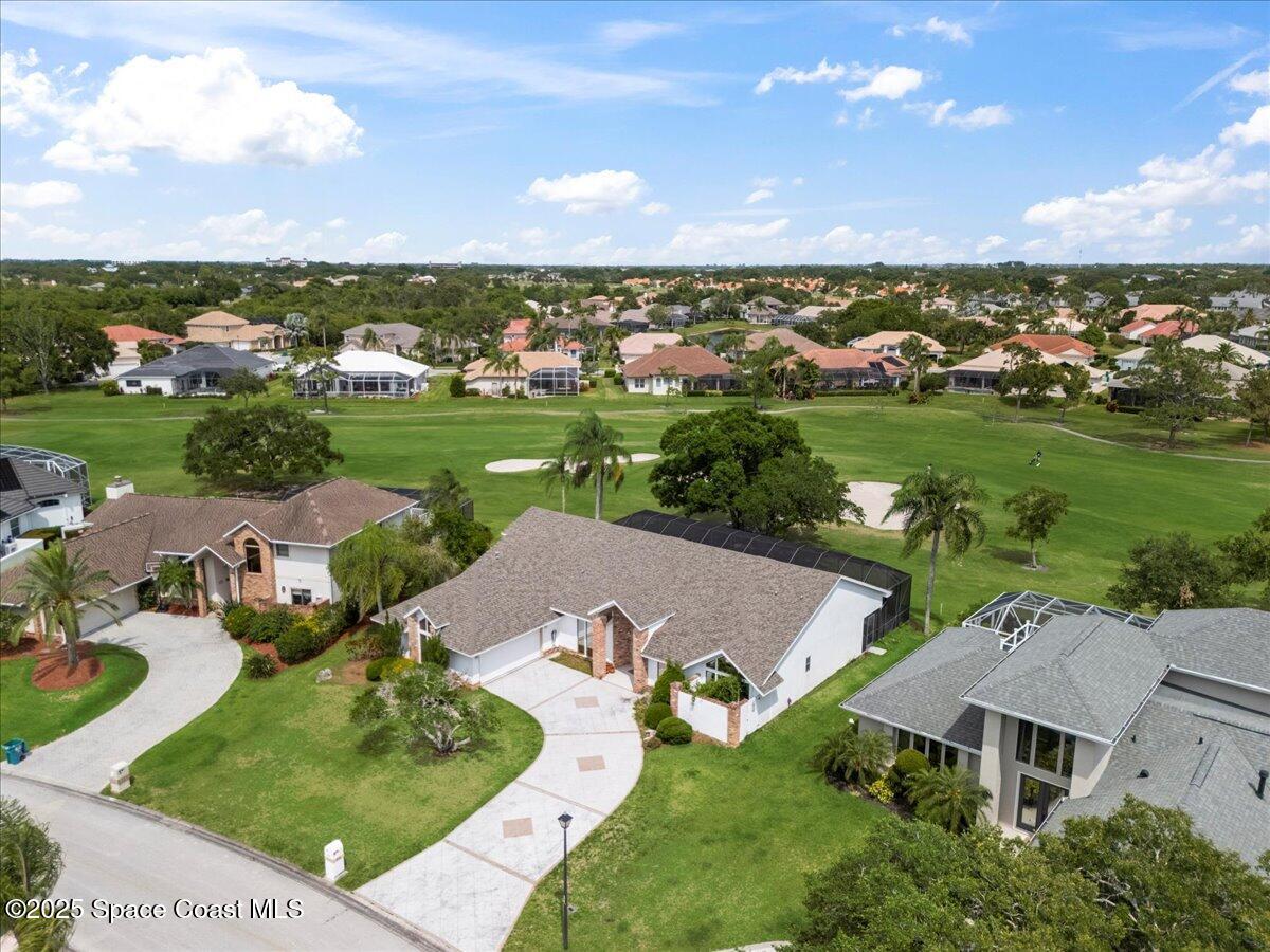 649 Spring Lake Drive Melbourne, FL 32940 - Photo 44 of 47 an aerial view of a house with yard and lake view in back