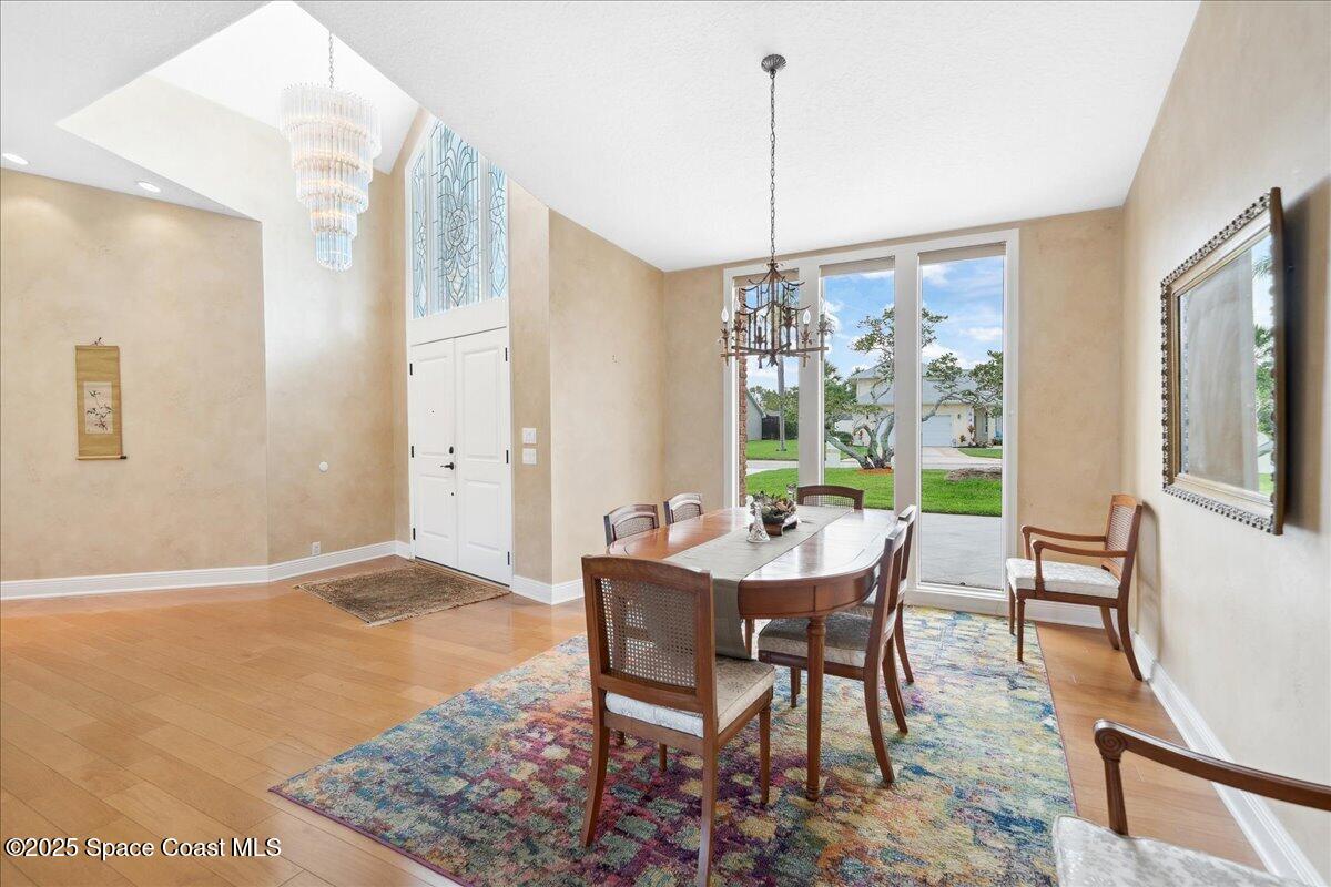 649 Spring Lake Drive Melbourne, FL 32940 - Photo 8 of 47 a view of a dining room with furniture window and wooden floor