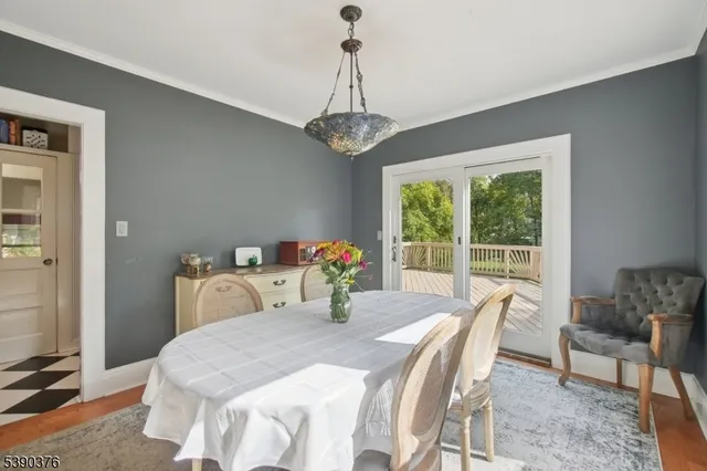 a dining room with furniture a chandelier and window