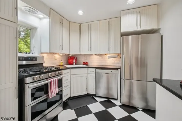 a kitchen with stainless steel appliances granite countertop a refrigerator sink and cabinets