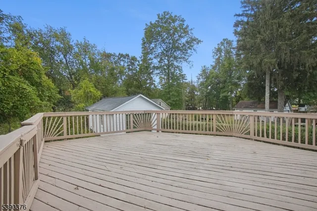 a view of a wooden deck with a trees in the background