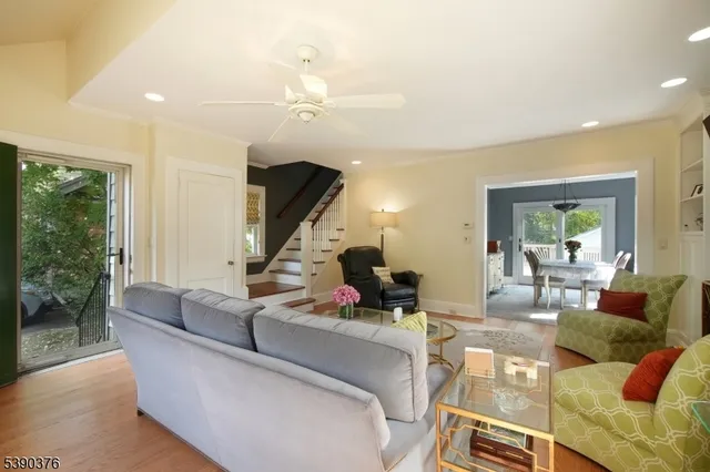 a living room with furniture and a chandelier