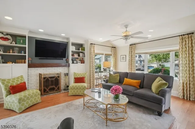 a living room with fireplace furniture and a flat screen tv