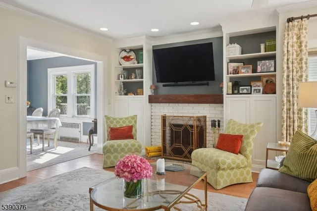 a living room with furniture fireplace and flat screen tv
