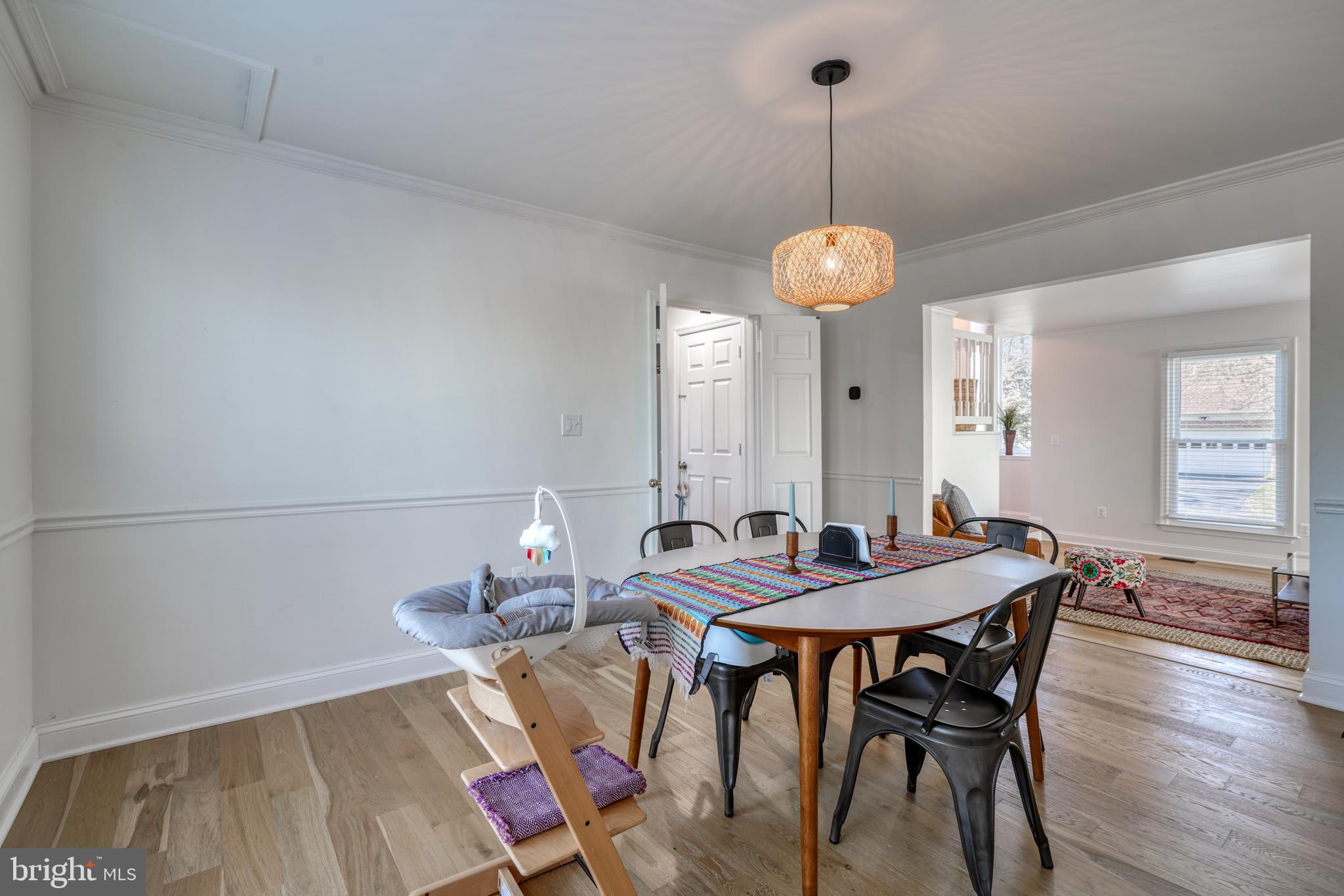 14235 Masterpiece Lane North Potomac, MD 20878 - Photo 18 of 66 a dining room with furniture a chandelier and wooden floor