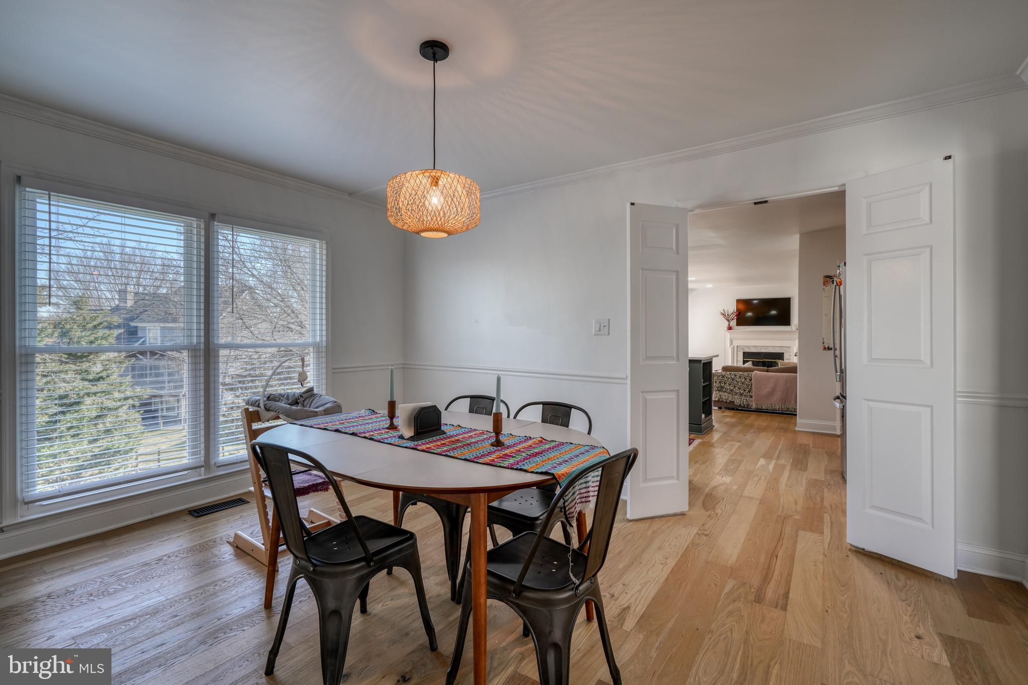 14235 Masterpiece Lane North Potomac, MD 20878 - Photo 19 of 66 a view of a dining room and livingroom with furniture wooden floor a chandelier
