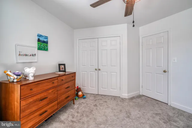 a bedroom with furniture and a flat screen tv