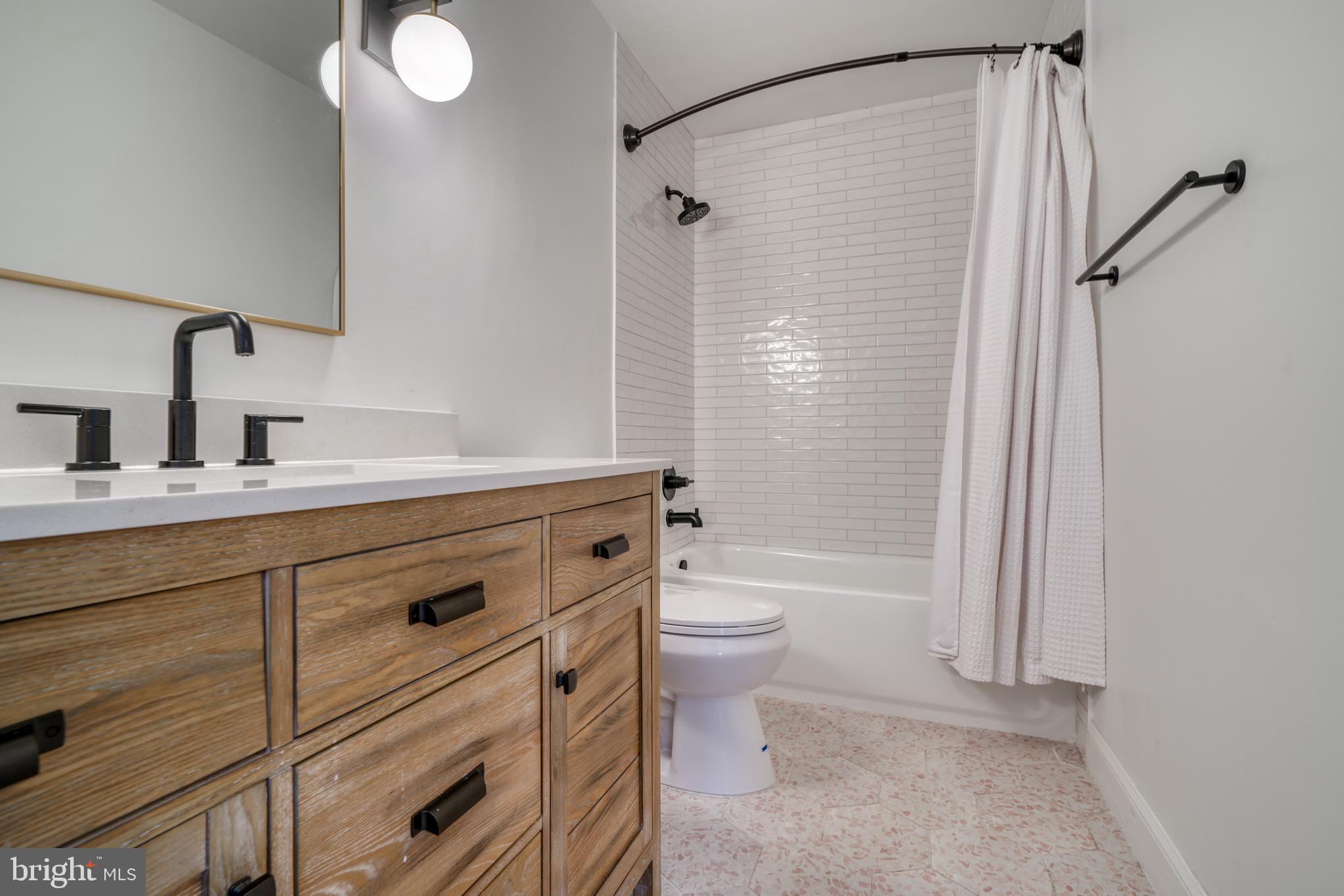 14235 Masterpiece Lane North Potomac, MD 20878 - Photo 35 of 66 a bathroom with a sink a toilet and shower