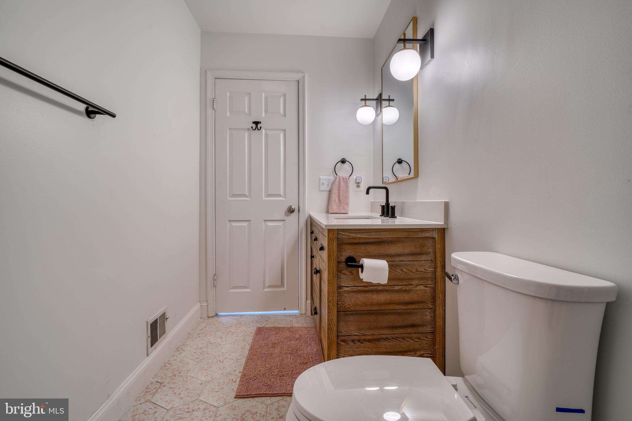 14235 Masterpiece Lane North Potomac, MD 20878 - Photo 36 of 66 a bathroom with a toilet a sink and mirror