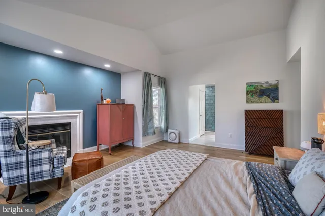 a room with a chandelier fan and a window