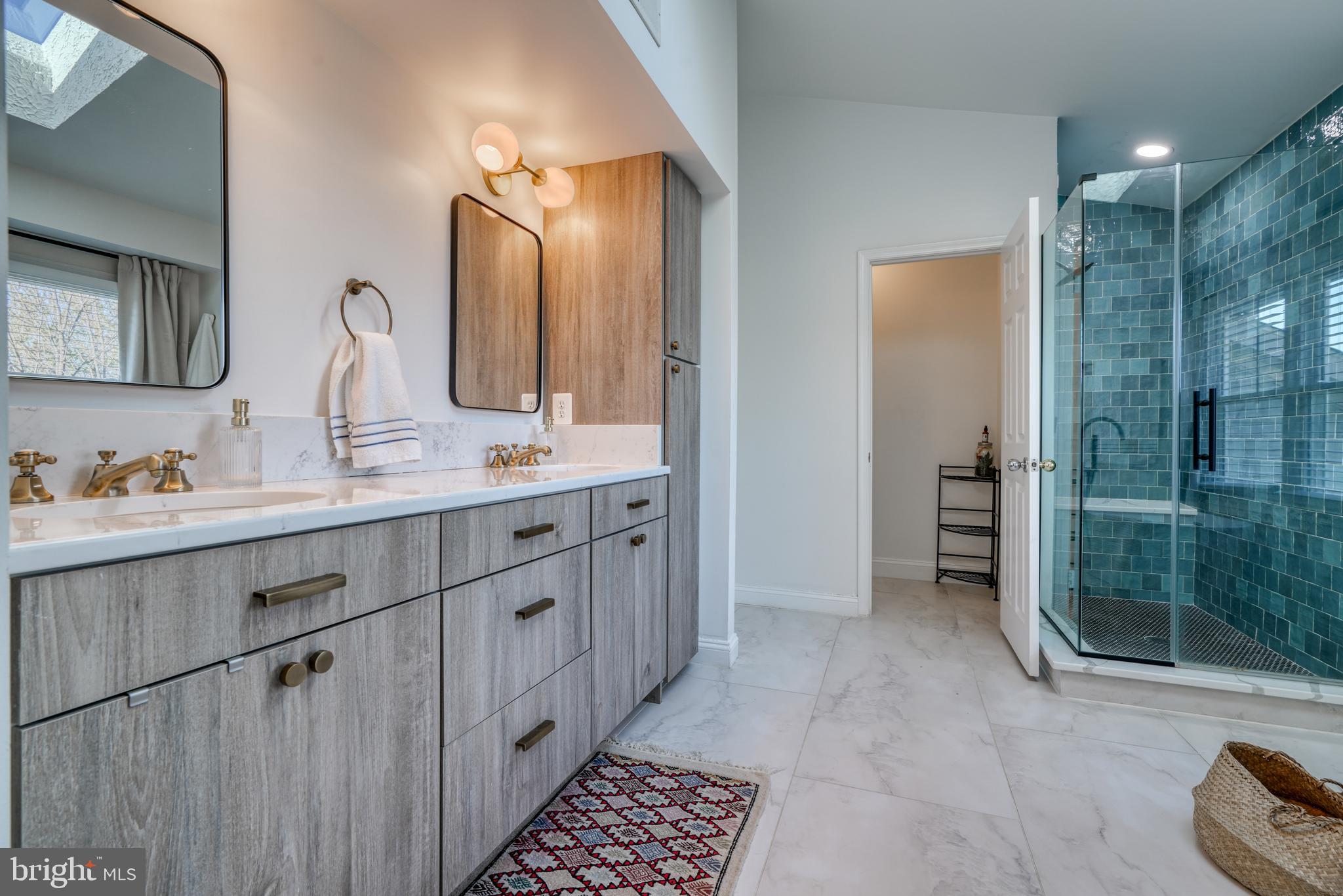 14235 Masterpiece Lane North Potomac, MD 20878 - Photo 45 of 66 a spacious bathroom with a mirror a double vanity sink and glass door