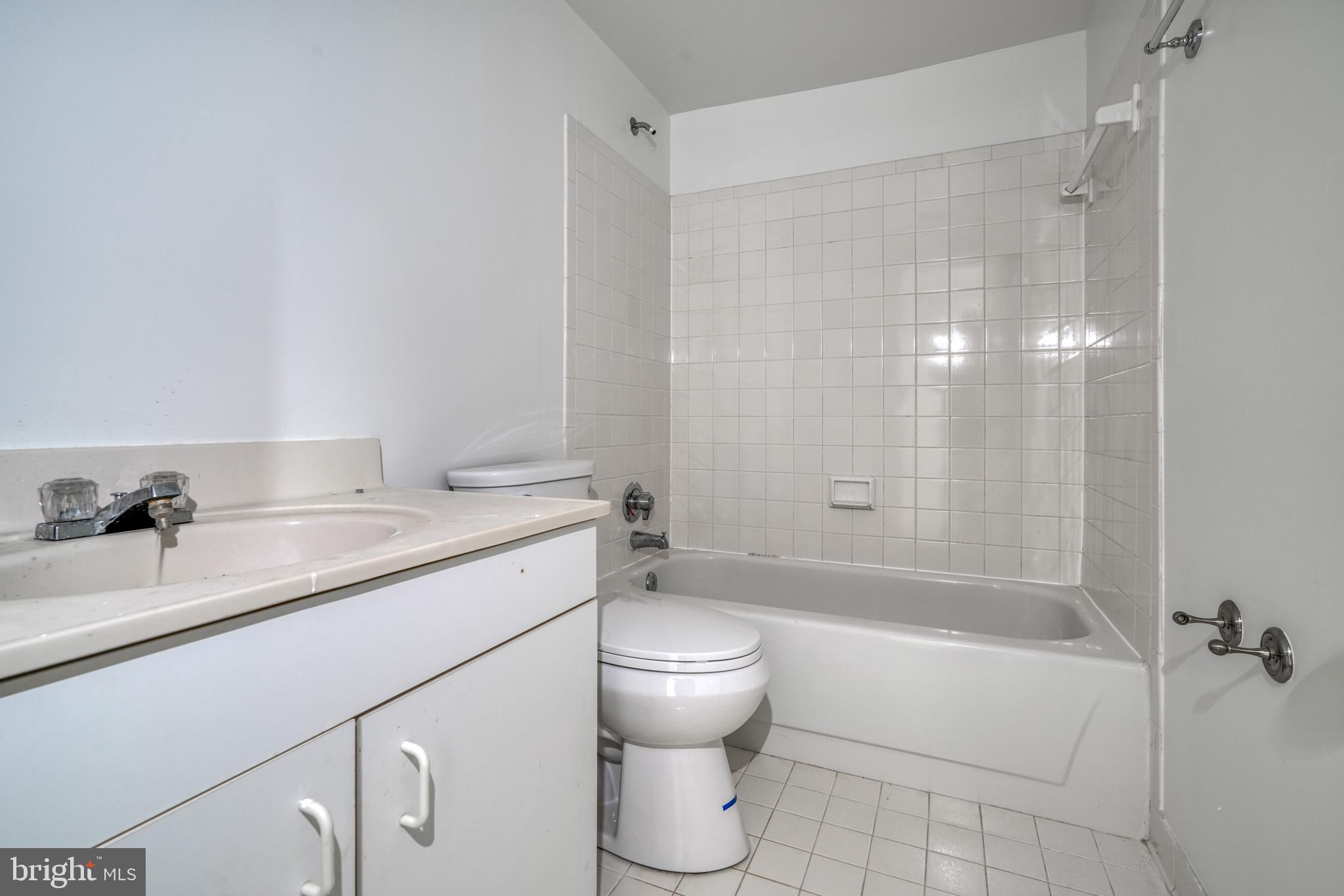 14235 Masterpiece Lane North Potomac, MD 20878 - Photo 58 of 66 a bathroom with a granite countertop sink toilet and shower