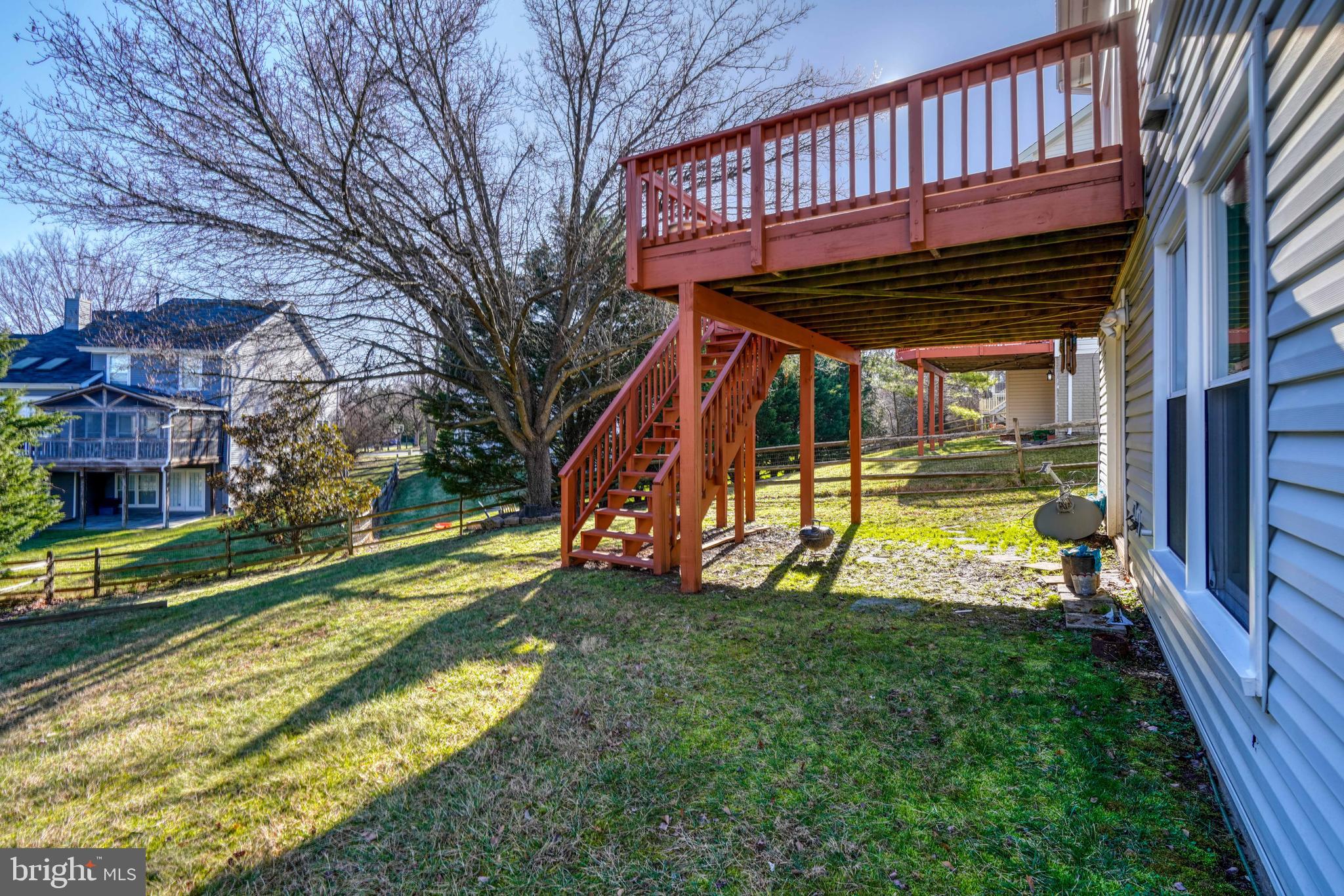 14235 Masterpiece Lane North Potomac, MD 20878 - Photo 63 of 66 a view of a backyard with a small deck and a large tree