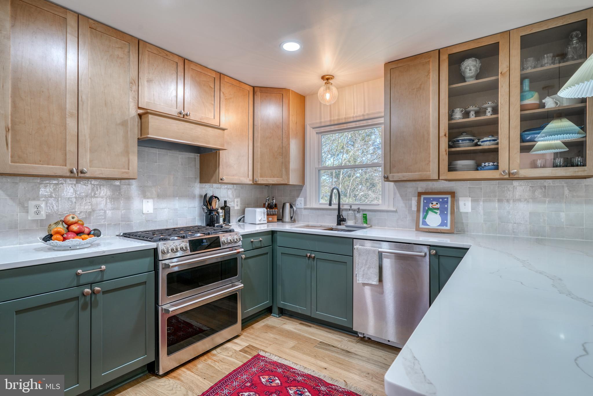 14235 Masterpiece Lane North Potomac, MD 20878 - Photo 9 of 66 a kitchen with stainless steel appliances granite countertop a stove and cabinets