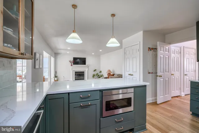 a living room with furniture a rug and a painting on the wall