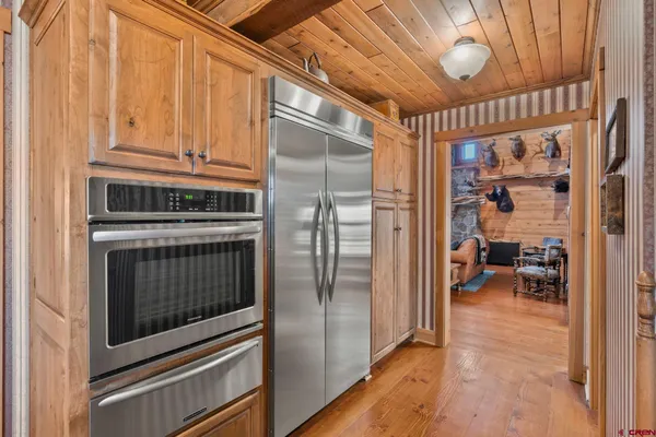 a large kitchen with a large window and stainless steel appliances
