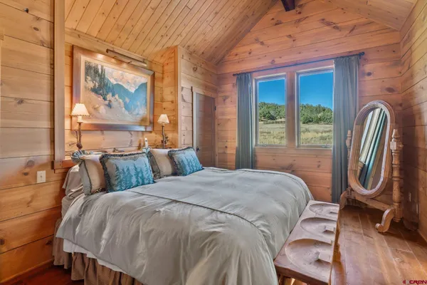 a bedroom with a bed and a mirror