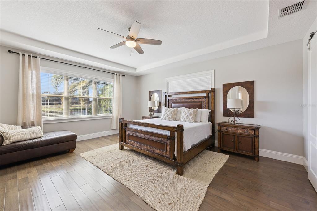 13436 Heswall Run Orlando, FL 32832 - Photo 14 of 72 a bedroom with a bed wooden floor and window