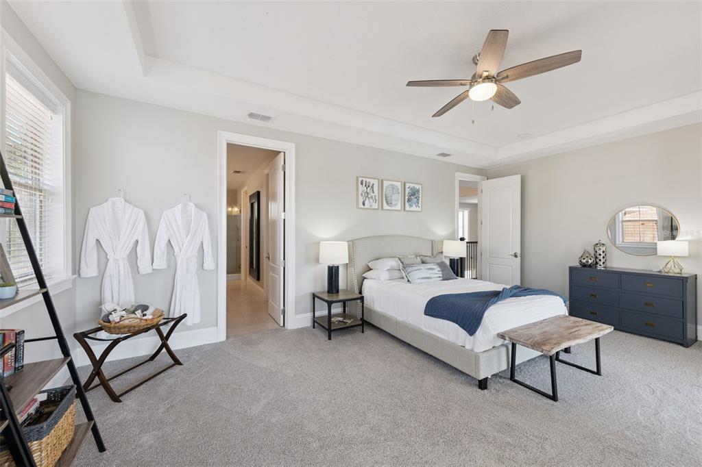 13436 Heswall Run Orlando, FL 32832 - Photo 21 of 72 a bedroom with a bed and a chandelier